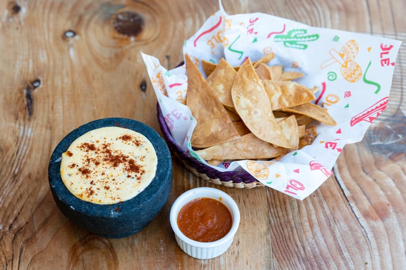 Queso dip soup bowl with tortilla chips at Chuys