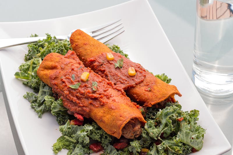 Chuys green chile enchiladas smothered in sauce